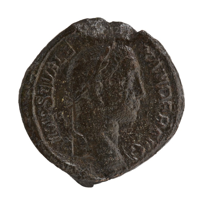 sestertius, Alexander Severus Roman emperor; 222–235 — iconography, personifications, Libertas personification, 229, Rome; Roman Empire 27 BC–476; coin; diameter 32.0–33.0 mm; weight 25.08 g, A round, dark brown object with an uneven, textured surface and a slightly irregular edge, showing the raised profile of a person's head in the center and a circular raised border around it; the surface has small lighter speckles and worn areas, and overall the visible colors are dark brown with hints of lighter brown and small flecks of yellowish tones.