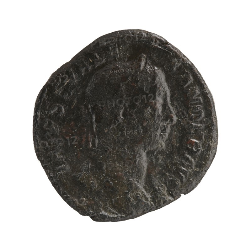 Sestertius; Roman deities; Alexander Severus Roman emperor, 222–235; iconography: Sol mythology; dated 230; Roman Empire 27 BC–476; place: Rome mint; coin; diameter 28.5–30.0 mm; weight 20.20 g, A worn dark brown circular coin with uneven edges showing a raised profile of a person facing right, with textured surface variations and small areas of lighter brown and reddish-brown patina.