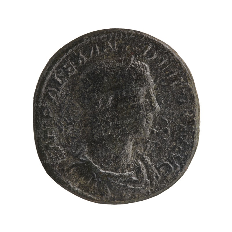 Sestertius; Roman deities; Alexander Severus Roman emperor, 222–235; obverse/reverse iconography: Sol mythology; date: 231; place: Rome, Roman Empire 27 BC–476; coin; diameter 29.0–30.0 mm; weight 20.11 g, A round, worn coin with a raised profile of a person's head facing right; the surface is textured and uneven with signs of wear. The coin appears dark with tones of black, dark brown, and hints of gray and greenish patina. There is a raised rim around the edge and faint raised decorative details surrounding the profile. The background is plain white.