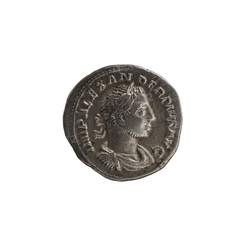 Denarius of Alexander Severus reigned 222–235 CE. Obverse: bust of Alexander Severus Roman emperor, 222–235 — titles/roles of issuer. Reverse: Mars Roman deity. Iconography linked to Alexander Severus, dated 231–235 CE. Roman Empire; Rome mint. Coin; diameter 18.5–19.5 mm; weight 3.04 g., A round metallic coin with a worn surface showing a raised profile of a man's head facing right, wearing a laurel or headband and short hair with a short beard, surrounded by a raised rim and a band of decorative markings around the edge; the coin appears silver-gray with darker gray patina in recessed areas and lighter gray on raised highlights, set against a plain white background.