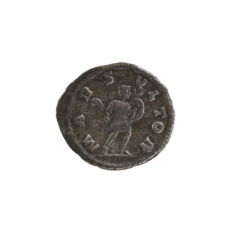 Denarius of Alexander Severus reigned 222–235 CE, obverse likely depicts the emperor; reverse features the Roman deity Mars. Roman Imperial coin, struck in Rome 231–235 CE. Materials and measurements: coin; diameters 17.5 mm and 20.0 mm; weight 2.66 g. Icons/inscriptions reference Alexander Severus titles and imperial titulature., A circular dark metallic coin with a raised rim showing a worn central relief of a standing human figure holding a round shield and an object in the other hand, the surface appearing textured and aged with lighter highlights on raised areas and darker brownish-gray and black tones across the coin.