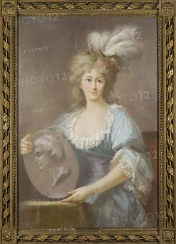 Portrait of Anna Charlotte Dorothea von Medem Biron, Duchess of Courland; after 1792 after an oil portrait by Marcello Bacciarelli, 1731–1818. Pastel, height 94.5 cm, width 64 cm. Copy attributed to Gustav Friedrich Amalius Taubert 1755–1839 copyist; possible unknown pastelist. Depicts Biron in 18th-century costume, en pied, wearing jewelry; iconography related to Stanislaw August Poniatowski and Dorota née von Medem 1761–1821. Restitution; gift; copies imitations., A portrait of a woman wearing a light blue dress with white lace trim and a purple sash, seated or standing against a muted brownish-gray background, her pale skin and rosy cheeks framed by voluminous blond hair adorned with white feathers and a small pink flower; she holds a round, grayish medallion or plaque showing a sculpted male profile and rests one hand on a brownish surface while the other supports the medallion, wearing a strand of white pearls on her wrist; the image is set within an ornate gold frame with braided...
