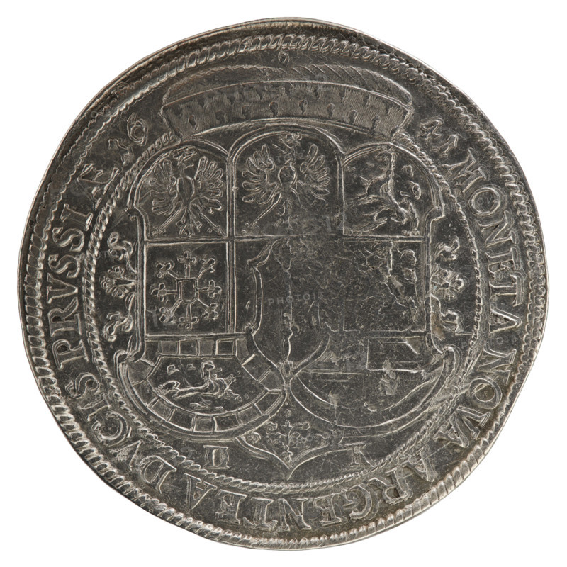 Thaler, ca. 1641. Obverse: torso in mitre and electoral mantle turned right, sceptre in right hand, left resting on sword hilt; figure's head divides inner border and rim; rim inscription FRID, WILH:D:G:MAR:BRA:SA:ROM:IMP:ARCH:E:EL:D:PR:. Reverse: under ducal mitre, dividing date numerals 16 -41, a nine-field coat of arms with ornaments; at bottom, on both sides of the shield D - K; rim inscription MONETA NOVA ARGENTEA DVCIS PRVSSIAE. Frederick William I Hohenzollern (Great Elector of Brandenburg; Duke of Prussia; 1620–1688) — Ducal Prussia (1525–1701), Königsberg. Coin: silver, diameter 45.8 mm, weight 28.59 g, axis 0°.