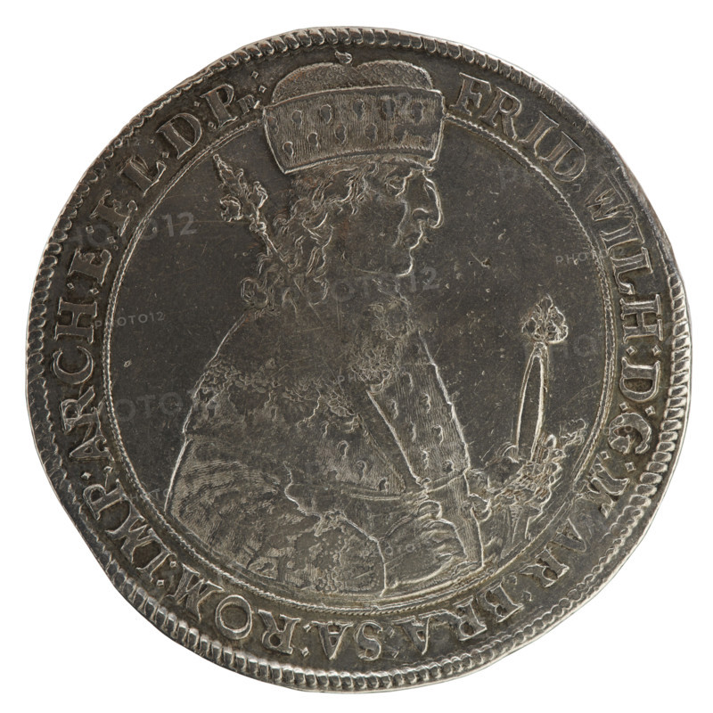 Thaler, ca. 1641. Obverse: torso in mitre and electoral mantle turned right, sceptre in right hand, left resting on sword hilt; figure's head divides the inner border and rim; rim inscription 'FRID, WILH:D:G:MAR:BRA:SA:ROM:IMP:ARCH:E:EL:D:PR:'. Reverse: under ducal mitre, dividing date numerals 16 -41, a nine-field coat of arms with ornaments; at bottom, on both sides of the shield D - K; rim inscription 'MONETA NOVA ARGENTEA DVCIS PRVSSIAE'. Ducal Prussia (1525–1701), Königsberg. Coin: diameter 45.8 mm, weight 28.59 g, axis 0°. Maker: Koch, Dawid; engraving: Bogumil Kantor.