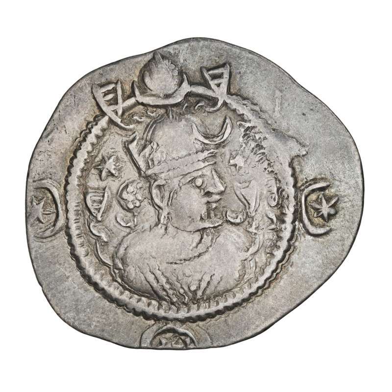 Drachma of Kavadh I (r. 488–496 and 498–531). Obverse: bust of Kavadh I facing right wearing a crown with ribbons, decorated with a crescent and korymbos; a crescent in front and two stars flanking the crown; short curly beard, curly hair tied back, one earring, beads and long chain at the neck, ribbons flowing from behind the shoulders, crescents on either side of the bust; three crescents with a central star in the field; Pahlavi legend. Reverse: fire altar; left of the altar the ruler facing forward holding a sword, right a priest facing forward holding a sword; star at top left and crescent at top right; signs/monograms at both sides; pearl rim; Pahlavi legend. Sassanid art/kingdom; Persia (Iran). Date: 488–497, 499–531. Coin diameter 26.0 × 29.0 mm; weight 4.07 g.