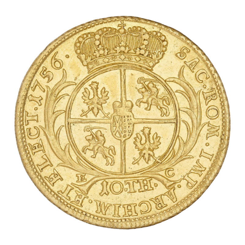 Double Augustor; maker: Croll, Ernest Dietrich (fl. 1753–1763). Subject: August III Sas (King of Poland 1733–1763; Elector of Saxony 1696–1763). Place/date: Leipzig, 1756. Object: thaler (coin). Obverse: Crowned bust of the king in right profile, with the Order of the Golden Fleece on the chest. Inscription: D:G:AUGUSTUS III.REX POLONIARUM. Reverse: Under a crown, a five-field shield surrounded by two palm branches, with Polish, Lithuanian, and Saxon coats of arms; at the bottom EC /10:TH. Inscription: SAC.ROM.IMP.ARCHIM. ET ELECT.1756. Edge: decorated with notches. Material: coin (metal). Diameter: 28.5 mm. Weight: 13.30 g., A circular metallic object with a golden color fills the image, showing a raised ornate design and decorative edge; at the top is a detailed crown with rounded and floral motifs, below which sits a large circular shield divided into four quadrants containing stylized figures of animals and riders, and a small central shield; flowing ribbon-like floral elements fla...