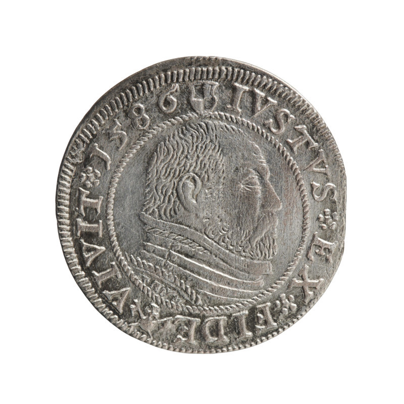 Grosz; Gulden; Pawel, publisher. Obverse: Prussian eagle with a crowned letter S on the chest, dividing the inner border; in the rim between the borders an inscription beginning with a rosette GEORG.FRID:D:G:M:BR:DVX.PRVSS. Reverse: Male bust in armour in profile to the right; short hair, beard with sideburns; in the rim between the borders an inscription beginning with the Hohenzollern coat of arms and divided by a ring topped with a cross with crossed hooks IVSTVS EX FIDE - VIVIT. Date: 1586. Place: Ducal Prussia (Königsberg). Type: coin (grosz/gulden). Diameter 22.3 mm; weight 1.87 g; axis 0°. Historical/person depicted: George Frederick (Duke of Karniów; 1539–1603).