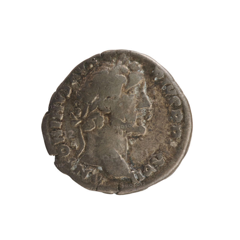 Denarius of Antoninus Pius (86–161; Roman emperor 138–161). Obverse: Emperor's head in a laurel wreath facing right; legend 'ANTONINVS AVG PIVS PP IMP II'. Pearl border. Reverse: Annona standing facing left, holding ears of corn above a modius in her right hand and a rudder resting on a ship's prow in her left; beaded border; legend 'TR POT XXI C OS IIII'. Hoard find (Golub). Attributes: Annona (personification), rudder, modius, ears of corn; imperial bust. Date: 157–158. Roman Empire (27 BC–476). Rome. Coin; weight 2.90 g; axis 180°.