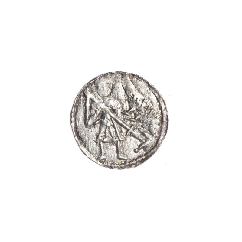 Denarius, Boleslaw III Krzywousty (prince of Poland; 1086–1138). Obverse: in a beaded border, a knight in chain mail thrusting a spearhead into the jaws of an upside-down dragon. Reverse: in a triple beaded border, an isosceles cross topped with balls; between its arms radiate two balls (smaller ones closer to the center, larger ones farther). Iconography: spearhead, chain mail, equal-armed cross, crosses, mouth, knight, martyrs, dragon, fight between good and evil, fight against pagans, Adalbert (Saint; ca. 956–997). Romanesque style. Date: ca. 1125–1138. Poland, Kraków. Coin (denarius). Diameter: 12.3–12.9 mm. Weight: 0.54 g. State of preservation: very good.