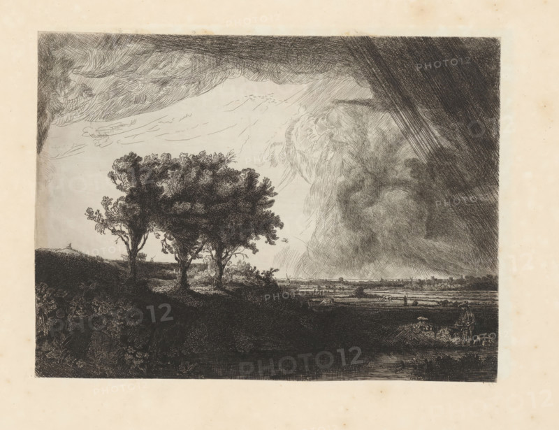 Three trees, print, album page, printmaker: William Baillie, after print by Rembrandt van Rijn, 1753 - 1810, Rembrandt van Rijn, after print by, paper, paste, etching, drypoint, etching and drypoint, pasted on album page, height 208 mm x width 279 mm, groups of trees, A monochrome etching shows a landscape with a dark foreground hill occupied by three leafy trees with textured trunks and branches, lighter vegetation along the hill's edge, and shadowed ground below; beyond the hill a flat plain stretches to a distant horizon with small clustered shapes suggesting buildings, low figures and scattered animals; the sky is filled with dramatic cloud formations rendered with dense crosshatching on the right and sweeping, lighter strokes on the left, creating contrasts between heavy shaded areas and open lighter sky above the plain.