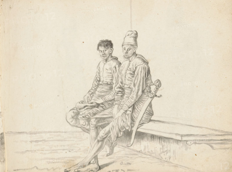 Two Sinhalese soldiers, sketchbook page, Outside by a wall – or inside in a corner of a building – two young men are sitting next to each other on a bench. A low retaining wall appears to have been built under the bench. Both men are drawn from a diagonal angle from the front, back to the right and legs, knees to the left. Both wear a half-length hip garment (veshti, lungi) wrapped in the Sinhalese style and a wide waistband. Above this, a short, buttoned-up jacket with long sleeves and a pleated hem (hettaya). A small collar hanging backwards is visible at the neck. The man on the left sits with bent knees and keeps his feet under the bench. On his lap, he holds a cap (?) with both hands. The man on the right sits with his legs stretched forward, left foot over the right. He keeps his arms outstretched, hands between his legs. His hair is hidden under a tall cap. He has a short, bushy beard. On his left hip he carries a long sword (kastane) with a decorated hilt; the sword's scabbard ...