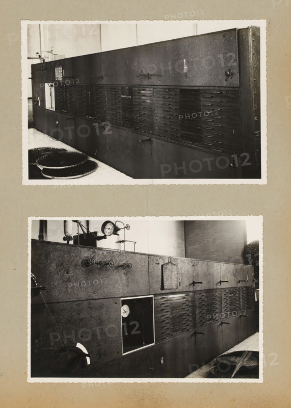 Installation, album page, photograph, Album page with two photos of an installation. Part of a photo album with photos of machines and constructions of the NV Machinefabriek Braat in Surabaya, Sukabumi, and Tegal from the period 1931-1937., Java, 1931 - 1937, photographer, paper, pasteboard, gelatin silver print, developed gelatin silver print, height 124 mm x width 184 mm, height 250 mm x width 320 mm, Person, NV Machinefabriek Braat, machines, parts of machines, tools and appliances, economic history, overseas history, company history, Period, A vertical composition showing two separate black-and-white photographs mounted on a beige page, each photograph depicting a long dark metal industrial cabinet with multiple horizontal slatted panels and small protruding handles; the top photograph shows the cabinet from an angled frontal view with circular woven trays on a tiled floor in the foreground and a plain wall behind, while the lower photograph shows a closer view of the same cabinet ...