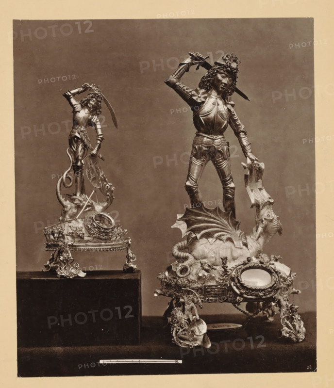 Reliquienbehälter with the figure of salvation. Georg, Two gold-plated silver reliquaries depicting Saint George and the dragon, photomechanical print, number: '36.', number: 'p.11, 3, 15', inscription: 'Blatt 62, Silber und vergoldet. 15. Jahrh., Im Besitze des Herrn Kaminski, Kreisgerichtsrath in Elbing. - 2) Silberner Reliquien-, Behälter with the Figur of Salvation. George. 15 Years. Im Besitz der St. Georgi-, Bruderschaft in Elbing.', Elblag, cliché maker: anonymous, after sculpture by anonymous, printer (person): attributed to Johann Baptist Obernetter, Munich, 1869 - 1887, photographer, after sculpture by, printer (person), Bavaria, Warminsko-Mazurskie voivodship, Attributed to, pasteboard, paper, collotype, photoprint, height 228 mm x width 192 mm, height 431 mm x width 540 mm, the warrior martyr George (Georgius), possible attributes: banner (red cross on white field), (red) cross, dragon, (white) horse, broken lance, shield (with cross), sword, relics (and reliquaries), Germa...