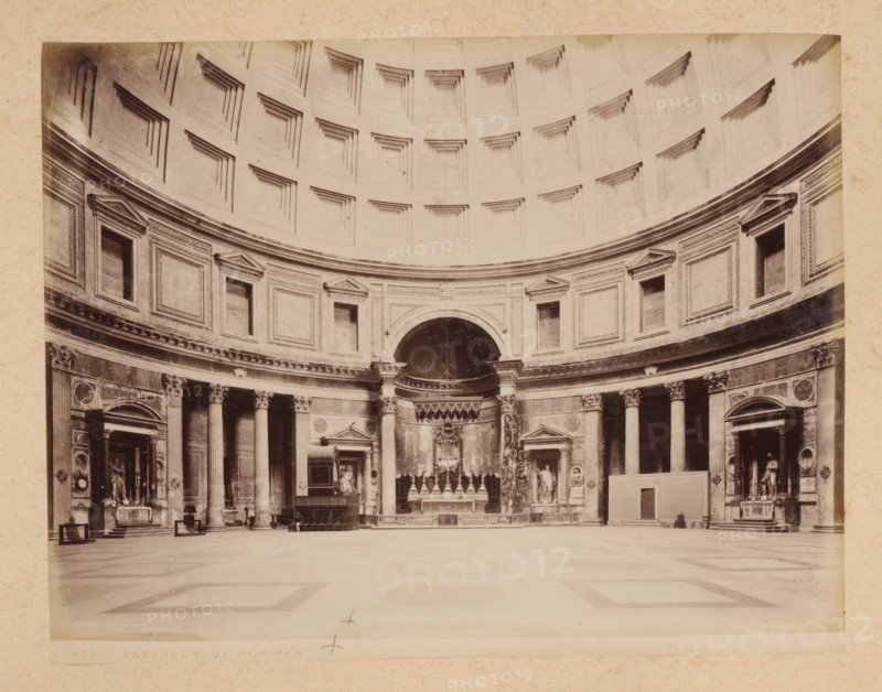 Interior of the Pantheon in Rome, album page, photograph, This photo is part of an album., inscription: '412 PANTHEON DI AGRIPPA', Pantheon, 1870 - c. 1895, photographer, Rome, paper, pasteboard, albumen print, height 203 mm x width 260 mm, temple, shrine, non-Christian religions, interior, representation of a building, A wide interior view of a large domed rotunda with a patterned coffered ceiling above a curved wall featuring rectangular recessed panels and framed niches, a central arched niche with decorative elements and an ornate altar area below, flanked by tall columns with carved capitals and entablatures, sculptural figures and framed architectural openings set into the wall, a broad smooth floor with subtle geometric inlaid patterns, and scattered furnishings such as benches and small freestanding structures near the perimeter.