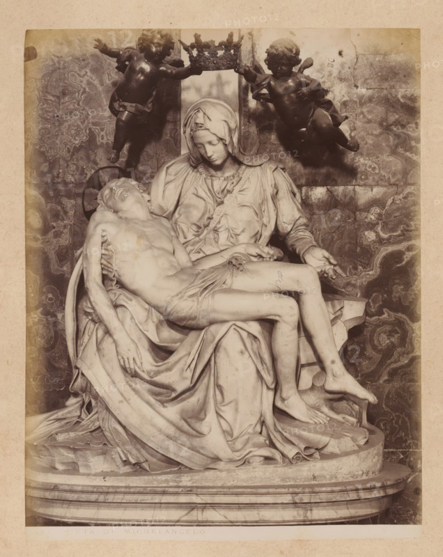 Pietà by Michelangelo in St. Peter's Basilica in Vatican City, album page, photograph, This photo is part of an album., inscription: '181 PIETA DI MICHELANGELO', St. Peter's Basilica, 1870 - c. 1895, photographer, Vatican City, paper, pasteboard, albumen print, height 259 mm x width 200 mm, piece of sculpture, reproduction of a piece of sculpture, interior of church, the dead Christ in Mary's lap, A monochrome photograph of a marble sculpture showing a seated woman wearing a head covering and flowing drapery, holding the limp body of a man across her lap; the woman's head is bowed and her hands support the man's torso and legs, while two winged childlike figures hover above holding a decorative crown between them; the figures rest on a rounded base with draped cloth and carved folds, and a patterned stone wall serves as the backdrop.
