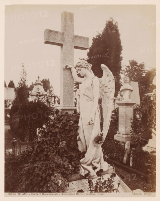 Monumento Maffei, Cimitero Monumentale, Milan, Italy, photograph, Angel sculpture by ... Pisani, Cimitero Monumentale cemetery, Italy., caption: '(EDIZIONI BROGI)', caption: '10776. MILANO - Cimitero Monumentale - Edicola Fossati, architetto Ernesto Quadri.', photographer: Edizioni Brogi, Florence, publisher: Giacomo Brogi, c. 1860 - c. 1890, Tuscany, pasteboard, paper, albumen print, height 252 mm, width 198 mm x width 510 mm, height 330 mm, Lombardy, A tall stone cross stands behind a marble statue of a winged female figure leaning with one arm against the cross and the other hand holding a small wreath, the figure wearing a draped gown and looking downward; the statue is surrounded by leafy plants and climbing ivy covering a mound in front, with a carved bust on a pedestal and other tomb monuments visible in the background, along with tall trees and scattered grave markers.