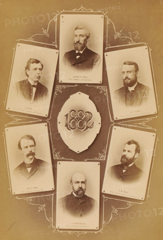 Six portraits of professors at Pennsylvania College, photograph, page, photographer: William H. Tipton, Gettysburg, c. 1877 - in or before 1882, North America, Pennsylvania, paper, albumen print, height 146 mm x width 101 mm, professor, A vertical collage of sepia-toned portrait photographs arranged around a central decorative oval medallion, each portrait mounted on a small rectangular card with rounded corners and pinned at the corners, showing men in formal late nineteenth-century attire with facial hair and stern expressions, decorative scrollwork framing the arrangement, and a lighter outer border around the darker central background.