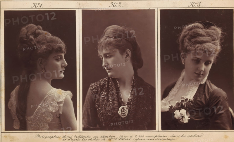 Lighting study, depicting a portrait of an unknown woman, photograph, page, number: 'No. 3.', inscription: 'Photographies demi-brillantes au charbon, tirées à 2, 500 copies, dans les workshops, et d'après les clichés de Mr. A. Liebert. (specimens d'éclairage)', photographer: Alphonse-Justin Liébert, c. 1873 - in or before 1878, Alphonse-Justin Liébert, photographer, paper, carbon print, height 104 mm x width 63 mm, historical persons not known by name - BB - woman, Three vertically framed sepia portraits of women arranged side by side within a bordered sheet, each woman shown from the shoulders up against a dark background. The left portrait shows a woman in profile facing right with an elaborate updo and long hair falling down her back, wearing a sleeveless dress with wide lace straps and a decorative earring; her exposed shoulder and upper back are visible. The center portrait shows a woman in three-quarter view looking down and to her left, hair swept back and held by a band, wearin...
