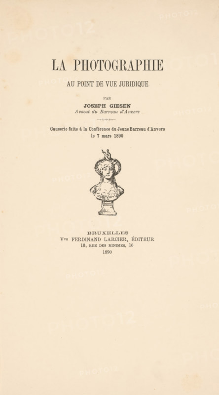 La photographie au point de vue juridique, book, annotation: 'NOV, 2000', 1890, paper, printing, height 252 mm x width 165 mm x thickness 7 mm, A vertical cream-colored page with an ornate title area near the top featuring bold dark lettering, a line of smaller dark lettering beneath it, and centered decorative printed text and ornamental marks leading down to an illustrated bust of a classical figure on a pedestal rendered in black ink, with additional lines of dark printed text below the illustration and light spotting and aging marks scattered across the paper.