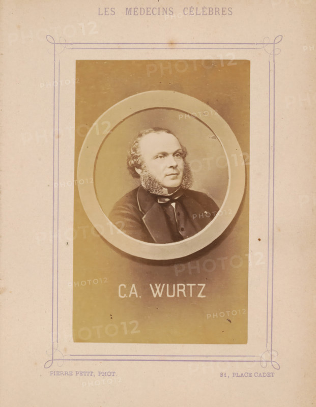 Portrait of Charles-Adolphe Wurtz, photograph, page, inscription: '(Publication de la Revue de literary médicale du, DF Bremond, 5 Rue Beudant, Paris. No.', photographer: Pierre Petit, c. 1871 - c. 1879, paper, albumen print, height 91 mm x width 56 mm, Person, Charles-Adolphe Wurtz, historical persons, adult man, A faded sepia portrait of a man with sideburns framed inside an oval mat, set against a rectangular background area on aged paper with decorative purple line borders and faint stains.