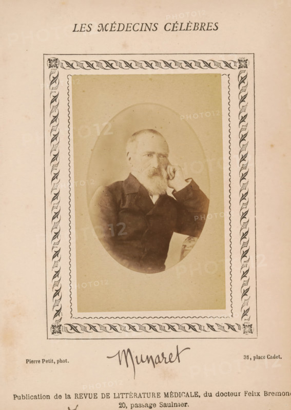 Portrait of an unknown man, photograph, page, annotation: 'Munaret', inscription: '(Publication de la Revue de literary médicale, du docteur Félix Bremond, 20, Passage Saulnier, Paris., e année - No.', number: '70', photographer: Pierre Petit, c. 1871 - c. 1879, paper, albumen print, height 82 mm x width 51 mm, historical persons, adult man, A sepia-toned portrait of an older man with a beard sitting with one hand resting against his cheek inside an oval frame, set within a decorative rectangular border with leaf-like patterns at the corners and along the sides, all printed on aged paper with faint spots and discoloration.
