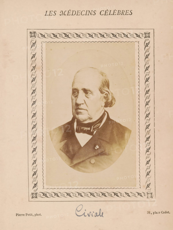 Portrait of Jean Civiale, photograph, page, annotation: '64', inscription: 'Publication de la Revue de literary médicale, du docteur Felix Bremond, 20, Passage Saulnier, e année- No.', photographer: Pierre Petit, c. 1871 - c. 1879, paper, albumen print, albumendruk, height 90 mm x width 56 mm, Person, Jean Civiale, historical persons, adult man, A faded portrait of an older man with a receding hairline and side-swept hair shown from the chest up, wearing a dark coat, vest, and bow tie, set inside an oval frame that sits within a decorative rectangular border featuring a repeating leaf-and-ribbon motif and corner floral designs, all on a beige, aged paper background.
