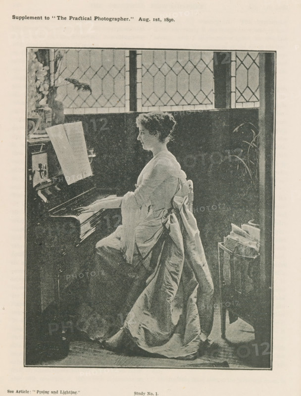 Woman playing piano, page, photomechanical print, inscription: 'See Article: 'Posing and Lighting.'', inscription: 'Supplement to 'The Practical Photographer.' Aug. 1st, 1890.', inscription: 'Study No. 1.', c. 1885 - in or before 1890, paper, autotype, height 147 mm x width 114 mm, Print on second unnumbered page after page 182., adult woman, keyboard instruments (artist at work), A monochrome image of a woman seated at a piano, shown in profile facing left, with hands on the keys and sheet music propped on the piano; she wears a long dress with a large bow at the back and a draped fabric that falls to the floor, and her hair is short and curly; behind her is a dark paneled wall and a tall window with diamond-patterned leaded glass, with a vase of flowers visible on a surface near the window; to the right of the woman a tall plant and a small stand holding folded papers or magazines are visible.