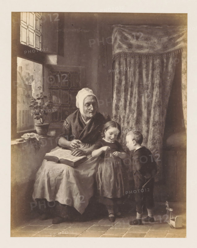 Photo reproduction of La leçon sollicitée by de Bruycker, photograph, reproduction, page, after painting by François Antoine De Bruycker, c. 1858 - c. 1863, photographer, paper, albumen print, albumendruk, height 152 mm x width 119 mm, picture, painting, old woman, education, science and learning, An interior scene shows an older woman seated by a window with a patterned curtain behind her, wearing a head covering and shawl, holding a book open on her lap and looking toward two children; a girl stands beside her holding a stringed object and smiling downward, and a boy stands facing the girl holding a small stick, with a toy on wheels near his feet; the window has leaded panes and a potted plant sits on the sill, a cloth draped nearby, and the floor is tiled.