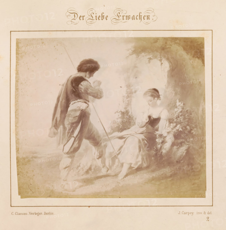 Awakening Love, Photographic reproduction of a design by a loving couple by J. Carpey, photograph, reproduction, page, number: '2.', after design by J. Carpey, publisher: Ch. Claesen Éditeur, Berlin, c. 1853 - in or before c. 1858, photographer, paper, albumen print, height 120 mm x width 143 mm, couple of lovers, A sepia-toned illustration shows a young woman seated on a low natural ledge under a leafy arch, wearing a light dress with a darker bodice and a headband, her head slightly bowed and one hand near her face while the other rests near foliage; a young man stands nearby facing her, dressed in period clothing with a cloak and holding a long staff, one leg bent as if stepping forward; the scene is bordered by a rectangular frame on aged paper with faint spots and discoloration.