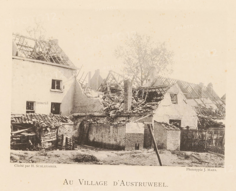 Au Village d'Austruweel, Destroyed houses in Oosterweel after the explosion of a munitions factory on September 6, 1889, page, photomechanical print, number: '15', photographer: Henri Schleusner, Oosterweel, cliché maker: Joseph Maes, 1885-09-06 - 1889-12-12, Henri Schleusner, Joseph Maes, photographer, cliché maker, paper, collotype, photoprint, height 119 mm x width 165 mm, prospect of village, silhouette of village, ruin of a building, architecture, Explosion of a munitions factory in Oosterweel in 1889, A sepia-toned scene shows ruined buildings with collapsed roofs and exposed wooden rafters, broken walls, scattered rubble, and debris. A partially intact multi-story building with a small window stands at one side, its adjacent structures reduced to jagged edges and piles of timber. A tall chimney and remnants of tiled roofing are visible among the wreckage, and a tree with sparse foliage rises behind the destroyed roofs. In the foreground low walls and a rough, uneven ground area ...