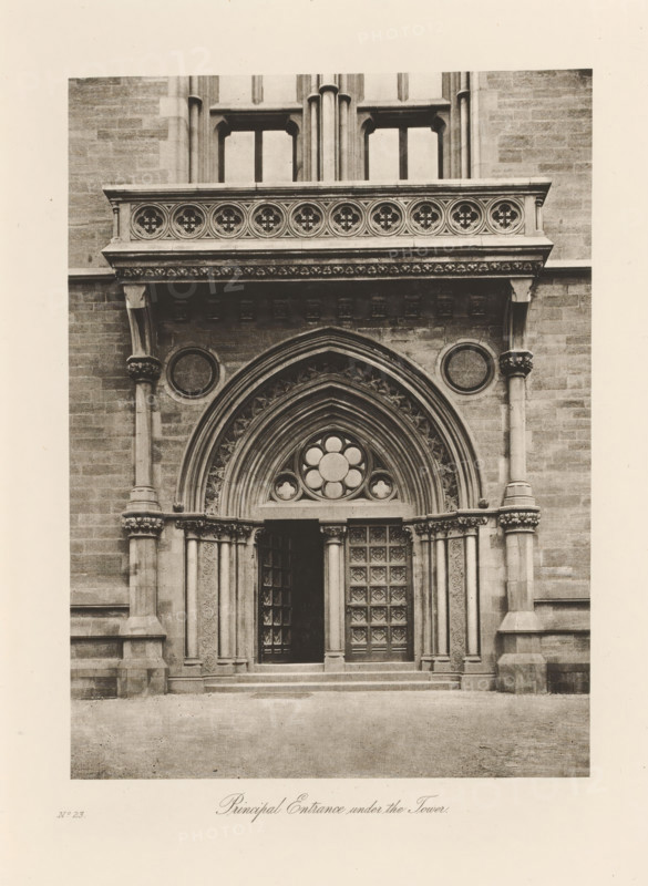 Main entrance to the University of Glasgow, Principal Entrance under the Tower, page, photomechanical print, inscription: 'No.23', cliché maker: T. & R. Annan & Sons, Glasgow, c. 1886 - in or before 1891, photographer, paper, photoaquatint, height 194 mm x width 142 mm, Print on twelfth unnumbered page after page xxxiii., gate, entrance, university (building, education, tuition), A stone entrance with ornate carved arches frames a pair of tall wooden doors, one of which is slightly ajar, each door panel featuring a grid of raised square designs; above the doorway a pointed arch contains layered concentric molding and a circular window with petal-shaped panes, flanked by decorative stonework and slender columns with carved capitals; a horizontal stone balustrade with circular floral motifs sits above a projecting cornice supported by corbels, and round recessed panels appear on the wall on either side of the arch; steps lead up to the entrance and the surrounding facade is composed of s...