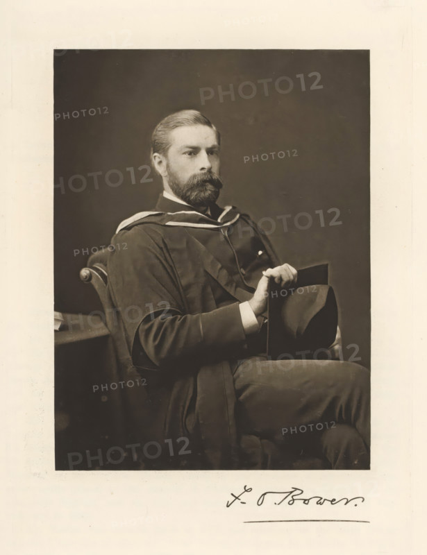 Portrait of Frederick Orpen Bower, FO Bower, page, photomechanical print, cliché maker: T. & R. Annan & Sons, Glasgow, c. 1886 - in or before 1891, photographer, paper, photoaquatint, height 193 mm x width 145 mm, Print on second unnumbered page after page 125., Person, Frederick Orpen Bower, historical persons, professor, A seated man with a full beard and neatly combed hair wears a dark academic gown with light trim and holds a hat in his lap while resting an arm on the chair; he looks slightly to the side against a plain dark background, and part of a table and the carved arm of the chair are visible.