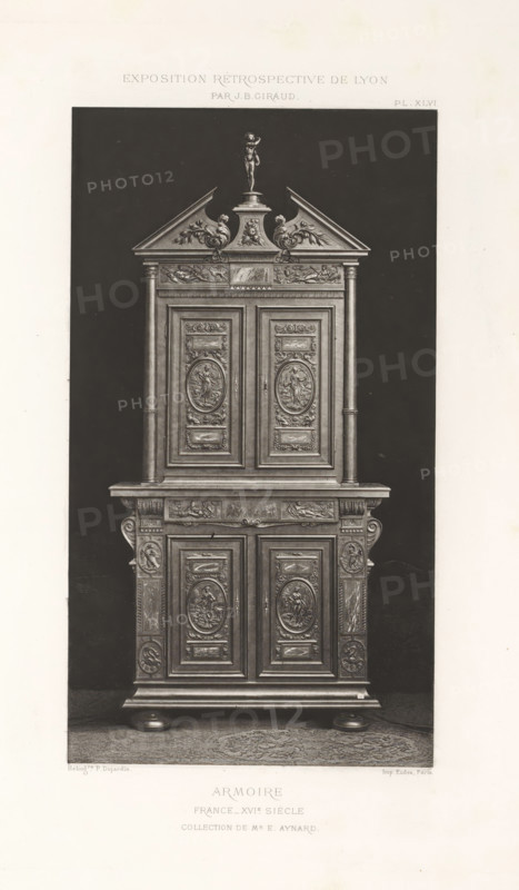 16th-century French wooden cabinet, at the Exposition Rétrospective of 1877 in Lyon, France, photomechanical print, This print is part of a cover with 79 prints on 54 sheets and 65 text sheets., inscription: 'EXPOSITION RÉTROSPECTIVE DE LYON, PAR JB GIRAUD.', inscription: 'ARMOIRE, FRANCE_16th Century, Collection of Mr E. AYNARD.', number: 'PL. XLVI.', photographer: Jacques Garcin, Lyon, cliché maker: Dujardin, printer (person): Imprimerie Eudes, Paris, 1877 - 1878, printer (person), paper, photoaquatint, height 463 mm x width 313 mm, ornamental cupboard (wood and other phytogenic material), A tall ornamental wooden cabinet with carved panels stands against a dark backdrop, featuring an upper section with a triangular pediment topped by a small standing figure, decorative scroll motifs at the pediment base, and a pair of fluted columns framing two carved doors with oval medallion reliefs; below is a wide shelf over a lower cabinet section with similarly carved doors, ornamented pilaste...