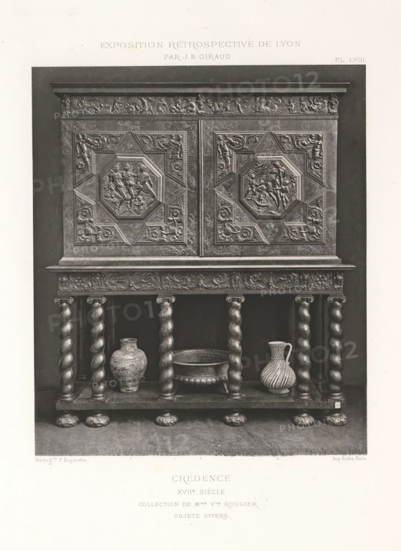 17th-century wooden sideboard, at the Exposition Rétrospective of 1877 in Lyon, France, photomechanical print, This print is part of a cover with 79 prints on 54 sheets and 65 text sheets., number: 'PL. LVIII.', inscription: 'CRÉDENCE, XVIIe SIÈCLE, COLLECTION DE Mme Vve ROUGIER, OBJETS DIVERS.', inscription: 'EXPOSITION RÉTROSPECTIVE DE LYON, PAR JB GIRAUD.', photographer: Jacques Garcin, Lyon, cliché maker: Dujardin, printer (person): Imprimerie Eudes, Paris, 1877 - 1878, printer (person), paper, photoaquatint, height 463 mm x width 313 mm, ornamental cupboard (wood and other phytogenic material), A detailed black and white photograph of an ornate wooden cabinet with two carved doors set on a turned-column stand, the cabinet doors each featuring a central octagonal panel with high-relief figurative scenes surrounded by geometric and foliate carvings, a carved frieze along the top with reclining figures and decorative motifs, a molded cornice and a carved apron above the stand, the st...