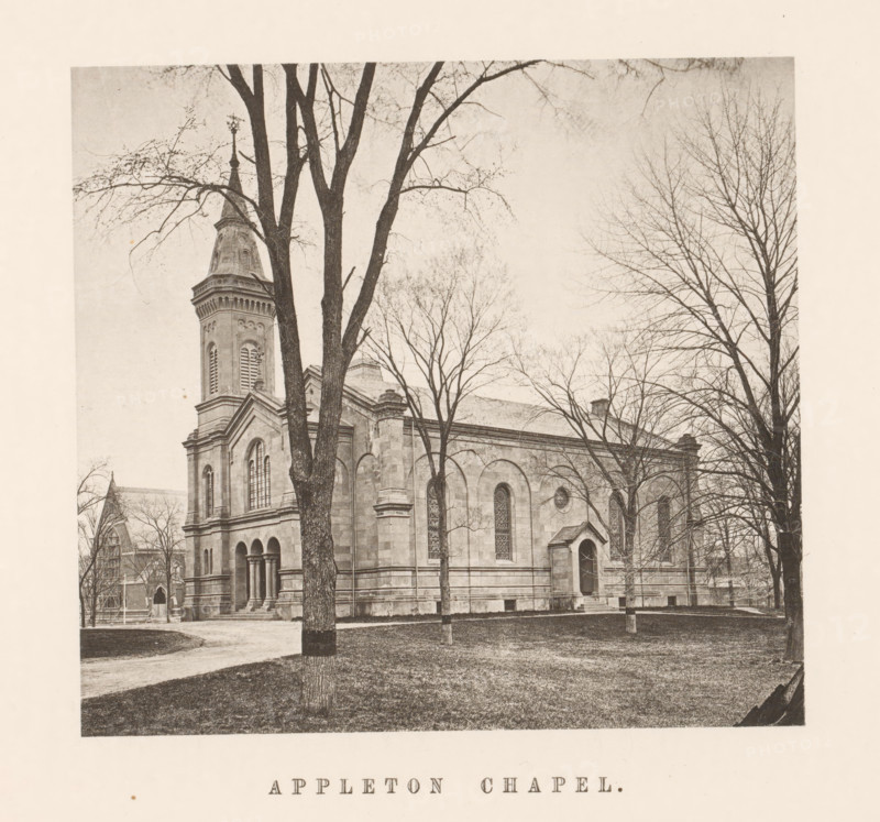 View of the Appleton Chapel of Harvard University, Appleton Chapel, page, photomechanical print, c. 1870 - in or before 1875, paper, collotype, photoprint, height 153 mm x width 165 mm, university building, college, North America, Massachusetts, Cambridge (MA), Harvard College, A sepia-toned photograph of a stone chapel with arched windows and a tall steeple partially obscured by leafless trees in the foreground, tree trunks and bare branches framing the building, a grassy lawn and a dirt path leading toward the chapel entrance, architectural details on the chapel facade including columns, cornices, and decorative stonework, and additional trees and parts of nearby buildings visible around the chapel.