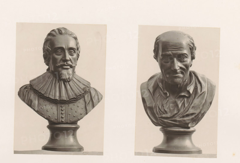 Busts of Voltaire and Hugo Grotius, photograph, page, photographer: Joseph Cundall, c. 1868 - in or before 1873, paper, carbon print, height 361 mm x width 270 mm, Person, Hugo de Groot, Voltaire, chest, bust, writer, poet, author, lawyer, attorney at law, Two grayscale photographic prints of sculpted busts mounted on a light background, positioned side by side. The left bust depicts a man with styled hair, a mustache and pointed beard, wearing a high, pleated ruff collar and a decorated garment with raised buttons, mounted on a rounded pedestal. The right bust shows an older man with a receding hairline, visible forehead wrinkles and pronounced cheek lines, wearing a loosely draped garment with textured folds and a rounded pedestal base.
