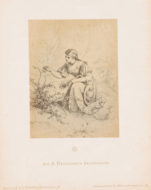 Photo reproduction of a sketch of a girl picking flowers by Albert Hendschel, Aus A. Hendschel's Skizzenbuch, photograph, reproduction, This photo is part of a cover with 50 photos on 48 sheets, a list of images and a title page., monogram: 'AH', number: '3', photographer: Theodor Huth, after design by Albert Hendschel, publisher: Ferdinand August Christian Prestel, Frankfurt am Main, c. 1865 - in or before c. 1870, Theodor Huth, Albert Hendschel, Ferdinand August Christian Prestel, photographer, after design by, publisher, Hessen, paper, albumen print, albumendruk, height 174 mm x width 130 mm, adolescent, young woman, maiden, picking flowers, A sepia-toned drawing of a young woman kneeling on grass beside leafy plants, wearing a dress with puffed sleeves and holding a woven hat filled with round objects at her side, her hair braided and tied, one hand extended toward a small stem while the other holds a bunch of foliage, with faint outlines of trees and branches in the background.