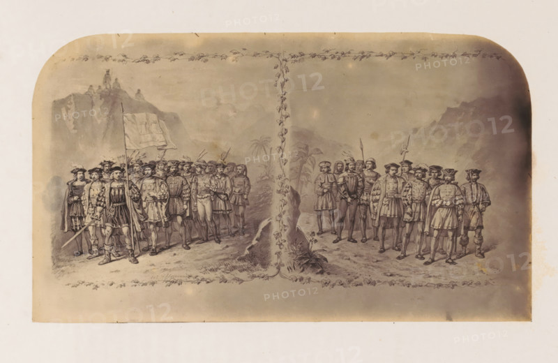 Photo reproduction of a print of Christopher Columbus and Vasco da Gama with their troops, photograph, reproduction, page, after print by anonymous, c. 1856 - in or before 1861, photographer, after print by, paper, albumen print, height 124 mm x width 214 mm, Person, Christopher Columbus, Vasco da Gama, land forces, exploration, expedition, voyage of discovery, A sepia-toned illustration shows two groups of men in period clothing standing on either side of a vertical vine that climbs from the bottom to the top of the image, the vine intersecting a horizontal garland that runs across the top. The men wear doublets, capes, plumed hats, hose, and boots, and several hold spears or swords while one figure near the left holds a flag with a draped cloth. In the background there are faint mountainous forms and palm-like trees, and on the far left a rocky outcrop with small seated figures. The scene is framed by a wide faded border with rounded top corners and a narrow decorative vine pattern a...