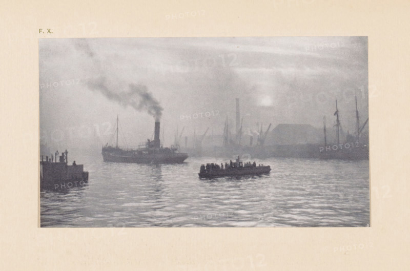 View of the Clyde near Glasgow, page, photomechanical print, inscription: 'FX', monogram: 'AG', inscription: 'The clyde by P. Bourgeois', photographer: Paul Bourgeois (possibly), Glasgow, cliché maker: anonymous, c. 1900 - in or before 1905, paper, autotypie, height 87 mm x width 150 mm, river, ships (in general), Clyde, A grainy grayscale scene of a harbor at dusk or dawn with calm rippling water in the foreground, a small crowded rowboat of silhouetted figures near the center, a larger steamship to the left emitting a plume of dark smoke, faint outlines of docks and industrial structures with cranes and masts along the distant shoreline, and a hazy sky above with a pale light source partially obscured by mist.