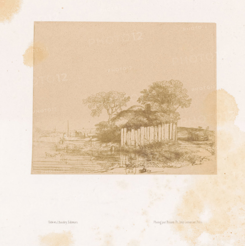 Photo reproduction of an etching of a farm with a white plank fence by Rembrandt van Rijn, photograph, reproduction, page, photographer: Bisson Frères, after print by Rembrandt van Rijn, printer (person): Lemercier, Paris, publisher: Gide et J. Baudry, c. 1848 - in or before 1853, Rembrandt van Rijn, after print by, printer (person), paper, salted paper print, height 130 mm x width 158 mm, farm or solitary house in landscape, A faded rectangular print with a light brown tone sits near the top of a pale sheet, showing a rural scene with a cluster of trees and a thatched structure behind a vertical wooden fence, reflections of the landscape visible along a horizontal waterline, faint outlines of boats and shore details at the water's edge, and irregular pale brown stains scattered around the sheet edges.
