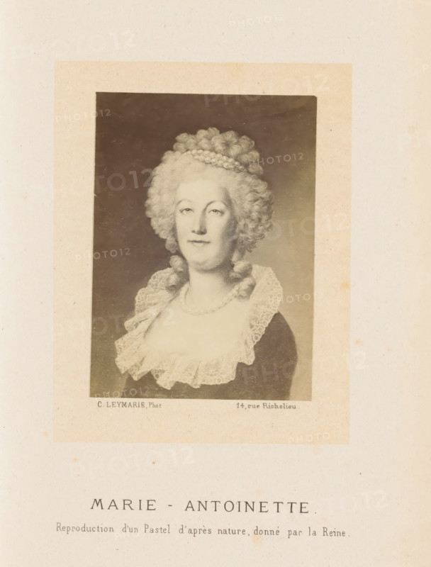 Photo reproduction of a drawn portrait of Marie Antoinette, photograph, reproduction, page, inscription: 'Reproduction d'un Pastel d'après nature, donné par la Reine', photographer: Charles Leymarie, Paris, after design by anonymous, c. 1861 - in or before 1866, paper, albumen print, height 88 mm x width 65 mm, Person, Marie Antoinette, historical persons - BB - woman, queen, A faded portrait of a woman in period dress is centered on an aged sheet, showing her from the chest up within a darker rectangular frame; she has pale skin and an elaborate high powdered hairstyle with curls and a braided band, a composed facial expression, and earrings; she wears a low neckline with a layered lace collar and a string of pearls at her neck, and the portrait area is surrounded by a lighter margin that sits on a textured beige background.