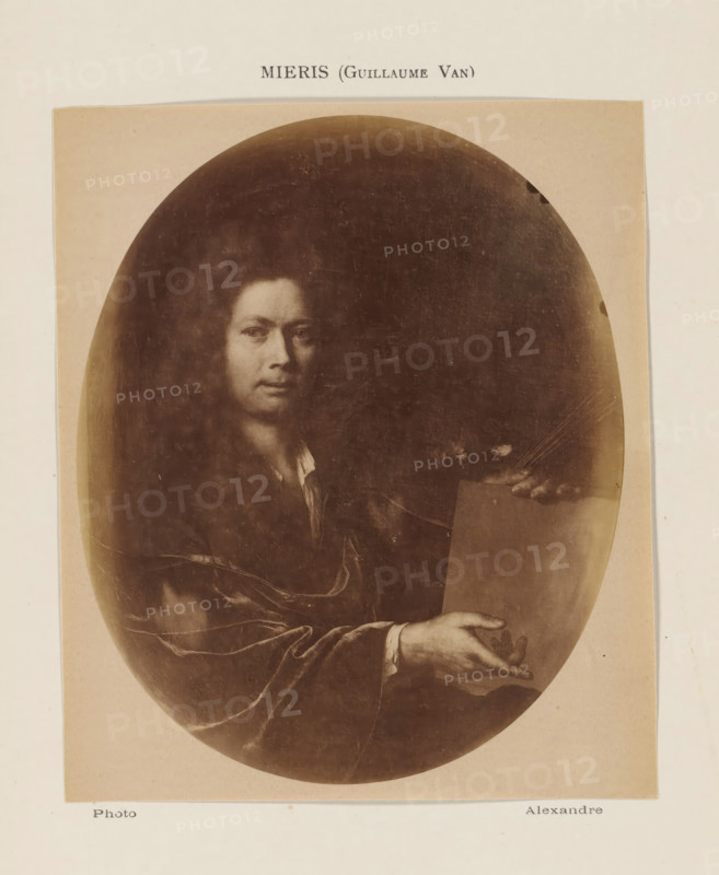 Photo reproduction of a self-portrait by Willem van Mieris, photograph, reproduction, page, inscription: 'Mieris (Guillaume Van)', photographer: Alexandre, after painting by Willem van Mieris, c. 1878 - in or before 1883, paper, albumen print, height 137 mm x width 103 mm, Person, portrait, self-portrait of painter, A sepia-toned oval photograph mounted on a pale rectangular sheet shows a portrait of a person with long curly hair and a composed facial expression, visible from the chest upward, wearing a dark draped garment with a lighter shirt collar peeking out; one hand is extended forward with an open palm resting on the edge of a flat surface while the other hand appears to hold a rectangular object, and the photograph has subtle scratches and spots.