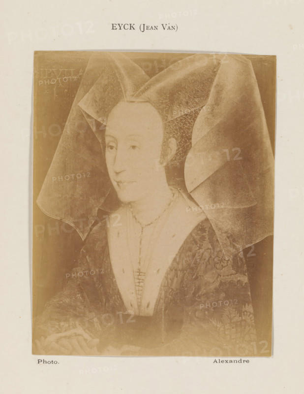 Photo reproduction of a portrait of Isabelle of Portugal by Rogier van der Weyden, photograph, reproduction, page, inscription: 'Eyck (Jean Van)', photographer: Alexandre, after painting by Rogier van der Weyden, c. 1878 - in or before 1883, paper, albumen print, height 130 mm x width 102 mm, Person, Isabella of Portugal, historical persons - BB - woman, A sepia-toned portrait of a woman wearing an elaborate headdress with wide translucent veils extending outward, showing a smooth, pale face with a calm expression and small, downcast eyes, a high forehead, and a narrow mouth; she wears a necklace and a low-cut garment with a patterned outer robe and visible stitching down the front, and her hands rest near the bottom edge where part of a floral shape is visible, all set against a dark rectangular background mounted on a lighter sheet.
