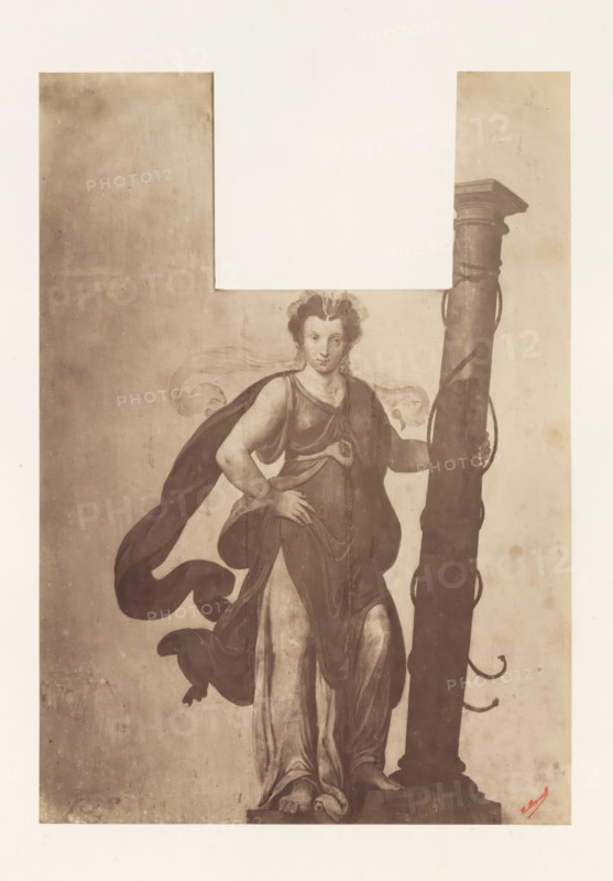 Photo reproduction of Sibyl with column by Lambert van Noort, photograph, reproduction, page, photographer: Edmond Fierlants, after painting by Lambert van Noort, publisher: C. Muquardt, Brussels, c. 1856 - in or before c. 1861, paper, albumen print, albumendruk, height 340 mm x width 241 mm, sibyls, A sepia-toned illustration of a standing female figure in flowing drapery with a cloak billowing behind her, one hand resting on her hip and the other holding a tall, ornate column beside her; she has curled hair and a calm facial expression, bare feet on a stepped base, and the background shows a rectangular lighter area at the top with a textured darker surface below.