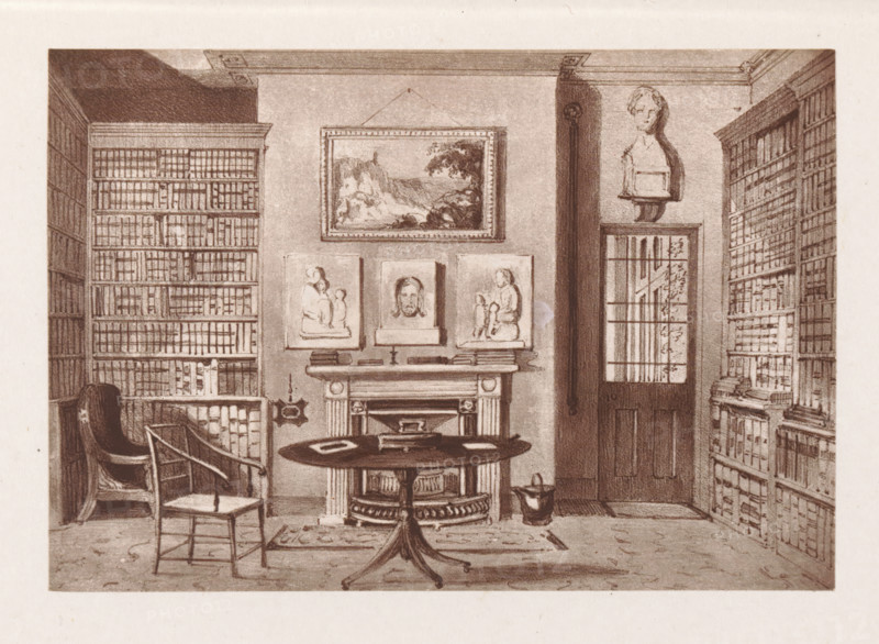 Photographic reproduction of a painting, depicting the interior of a library in the rectory of Herstmonceux, reproduction, page, photomechanical print, cliché maker: Woodbury Permanent Photographic Printing Company, after painting by Augustus Hare, Herstmonceux, c. 1866 - in or before 1876, photographer, East Sussex, paper, Woodburytype, Woodburytypie, height 84 mm x width 121 mm, study, 'studiolo', library, interior, representation of a building, A sepia-toned interior view of a room with tall bookshelves lining both sides, filled with rows of books; a round table with objects on it stands in front of a fireplace that has framed reliefs and a portrait above the mantel; a sculpted bust sits on a high shelf near a door with a window of panes; two chairs are placed near the table, one with a curved back and the other plain; a small rug lies beneath the table and a container rests on the floor beside the fireplace.