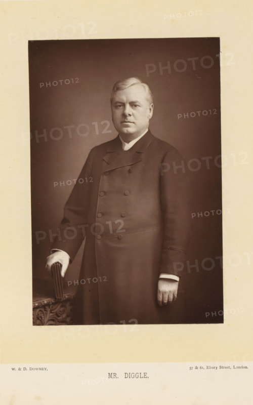 Portrait of Joseph Robert Diggle, Mr. Diggle, page, photomechanical print, inscription: '57 & 61, Elbury Street, London.', photographer: Downey, William & Daniel, London, cliché maker: anonymous, c. 1882 - in or before 1892, paper, Woodburytype, height 140 mm x width 93 mm, Person, Joseph Robert Diggle, politician, eg party leader, organization, functionaries and dignitaries in Roman Catholic church, clergy in general, A sepia-toned portrait of a middle-aged man standing and facing forward, wearing a double-breasted dark coat with a high collar and visible buttons, his left hand resting on an ornately carved surface while holding a small folded object, his right arm hanging by his side with a visible ring on a finger, short neatly combed light-colored hair, a neutral facial expression, and a plain dark background surrounded by a wide light-colored mat.
