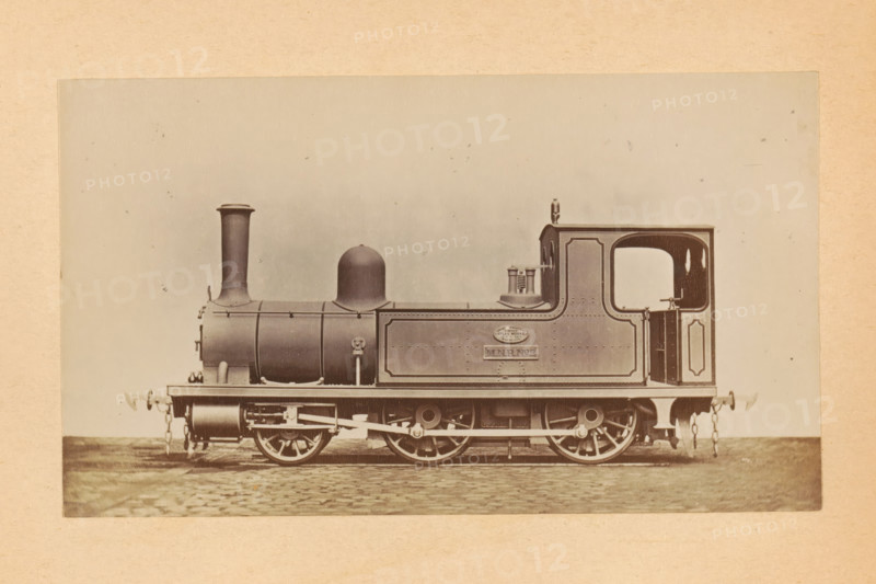 Steam locomotive for passenger transport made by Sharp, Stewart and Company, photograph, page, number: '774', inscription: 'Class 774. Passenger tank engine', c. 1874 - in or before 1884, photographer, paper, albumen print, height 83 mm x width 143 mm, steam locomotive, A sepia-toned photograph of a steam locomotive shown in profile on a cobblestone surface, with a tall cylindrical smokestack at the front, a rounded dome behind it, a rectangular cab with an open cab doorway and an arched window cutout, and a tank-like side panel with decorative border molding; visible running gear includes large spoked driving wheels, connecting rods, springs, and buffers with chain links at both ends, and small external fittings and pipes along the boiler and side tank.