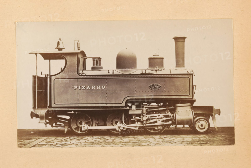 Steam locomotive made by Sharp, Stewart and Company, photograph, page, inscription: 'Class 839. 'Mogul' tank engine.', number: '839', c. 1874 - in or before 1884, photographer, paper, albumen print, height 82 mm x width 141 mm, steam locomotive, A sepia-toned photograph of a steam locomotive shown in profile on a cobbled surface, with a rectangular tank body featuring riveted panels and decorative trim, a curved cab roof with an open rear, a tall cylindrical smokestack, a rounded dome and a smaller cylindrical fitting on top, exposed driving wheels and connecting rods, visible pistons and mechanical linkages, a bell and small fittings on the roof, and a circular maker's plate on the side.