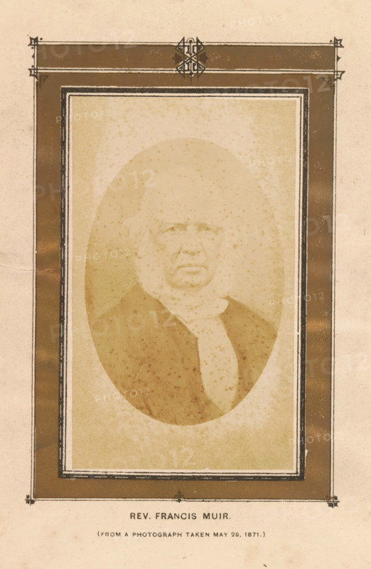 Rev. Francis Muir, photograph, page, Leith, 1871-05-29, photographer, paper, albumen print, albumendruk, height 94 mm x width 54 mm, Photo on frontispiece., Person, Francis Muir, historical persons, A faded sepia portrait of an older person with a rounded face and short hair, shown from the chest up and wearing a dark coat and a light scarf or cravat, set within an oval vignette surrounded by a decorative rectangular frame with dark borders and ornamental corner details, all on textured aged paper with small spots and foxing.