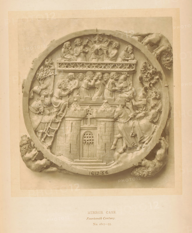 Mirror case, page, photomechanical print, number: 'No. 1617-55.', inscription: 'Fourteenth Century.', London, c. 1867 - in or before 1872, paper, Woodburytype, height 126 mm x width 113 mm, sculpture (relief, sculpture), castle of Love, A round carved relief set within a larger rectangular mat showing a circular border with sculpted figures and decorative elements around its edge; inside the circle a central gate with masonry towers and a barred doorway sits at the bottom, above which a platform with a crenellated parapet holds a group of standing and seated human figures in medieval dress engaged in various gestures; above them on a higher ledge more figures appear, some holding objects and one with wings, while flanking the central scene on both sides are mounted figures on horses and attendants, straps and patterned textiles visible on the horses and riders; the circular border includes sculpted animal heads and a lion-like creature gripping the rim at the lower left and right, and ...